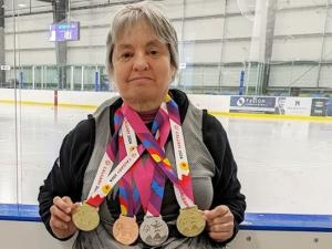 Terrylinn Johnson shows off her most recent medals.