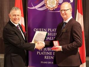 Darryl Rempel of Niverville receives his Queen Elizabeth II Platinum Jubilee medal from MP Ted Falk.