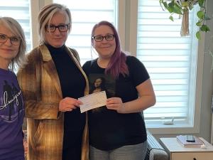 Mona Stott and Mona Dumont present Imagine's donation to Nadine Huberdeau.