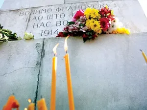 People in Belgrade lay flowers and light candles in front of Monument of Friendship with France and Serbia