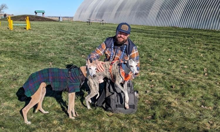 Kelvin Cech at the dog park with Rebis and Dasher.