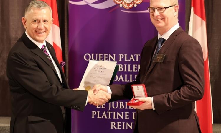 Darryl Rempel of Niverville receives his Queen Elizabeth II Platinum Jubilee medal from MP Ted Falk.