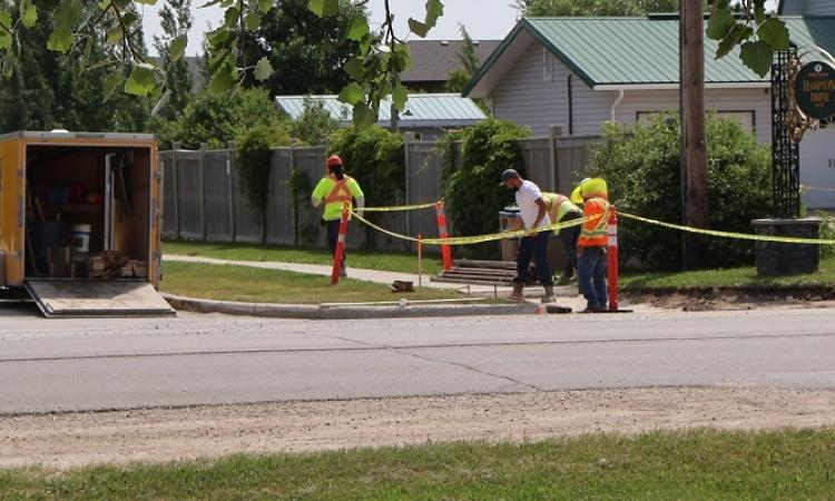 Sidewalk work is underway along Fifth Avenue in preparation for the installation of new crosswalks.