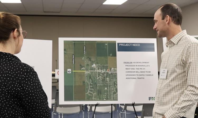 James Kennedy of of Morrison Hershfield speaks with a resident of Niverville at an open house to discuss the future build-out of Highway 311.