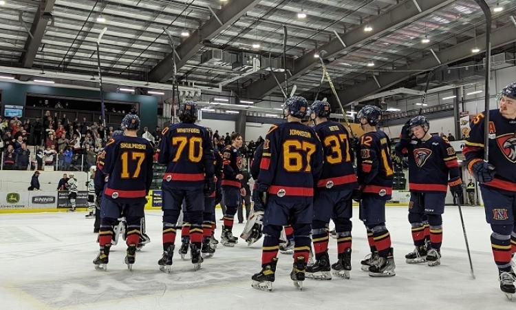 After their game five elimination in Portage, the Nighthawks raise their sticks at centre ice.