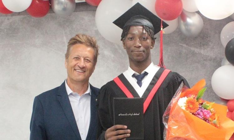 Graduate Michael Katotoka receives the Ron R. Schuler Citizenship Award.