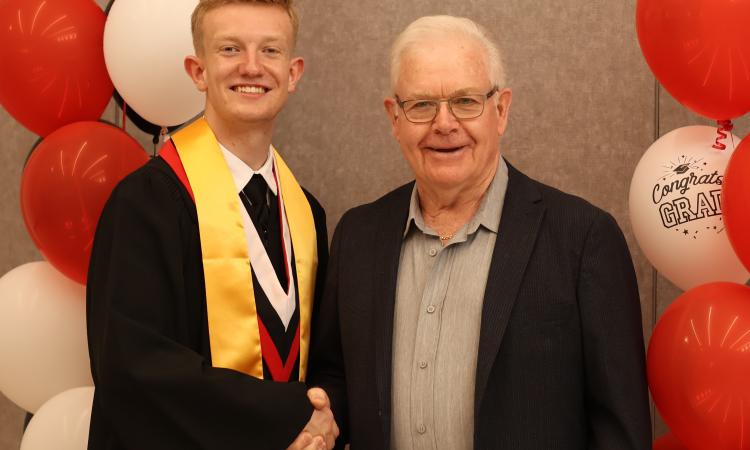 Sandy Wallace presenting the Manitoba Credit Unions Award to Jack Grantham.