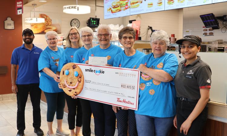 Volunteers for Niverville's mobility van fundraising committee receive a cheque from the Niverville Tim Horton's staff.