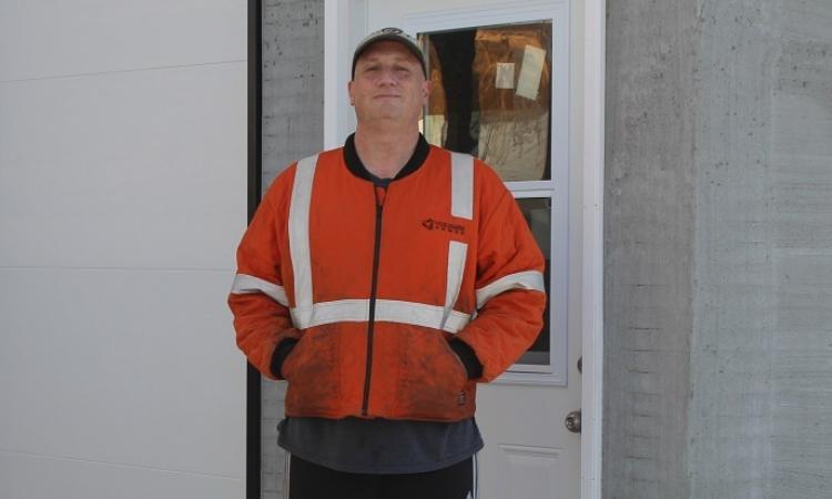 Cameron Bennett outside his blacksmithing shop in St. Adolphe.
