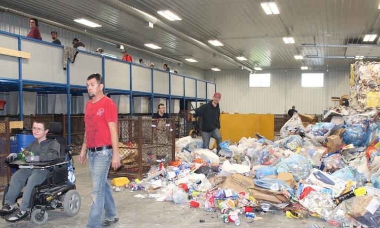 Workers at the SMILE of St. Malo Inc. recycling depot.