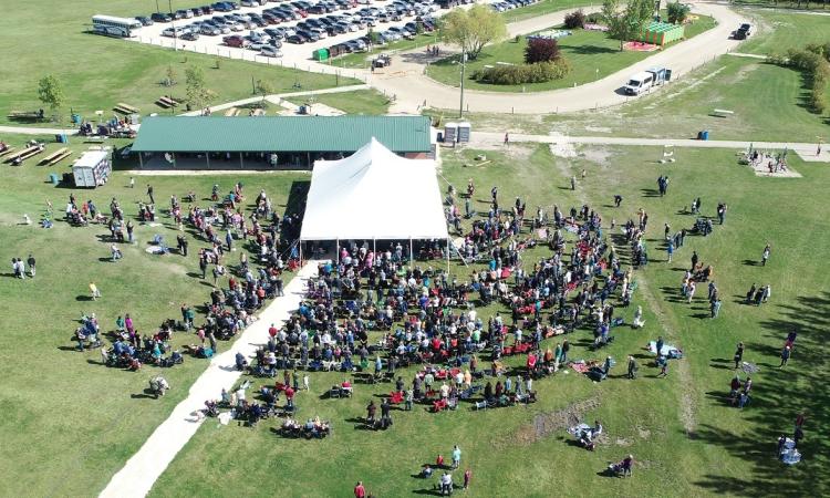 Visitors crowd in around the main tent at Niverville 50th anniversary party in Hespeler Park.