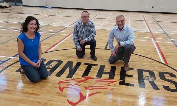 Principal Kimberley Funk, HSD Director of Facilities Bob Proulx, and HSD Superintendent Randy Dueck in the Niverville High School gymnasium.