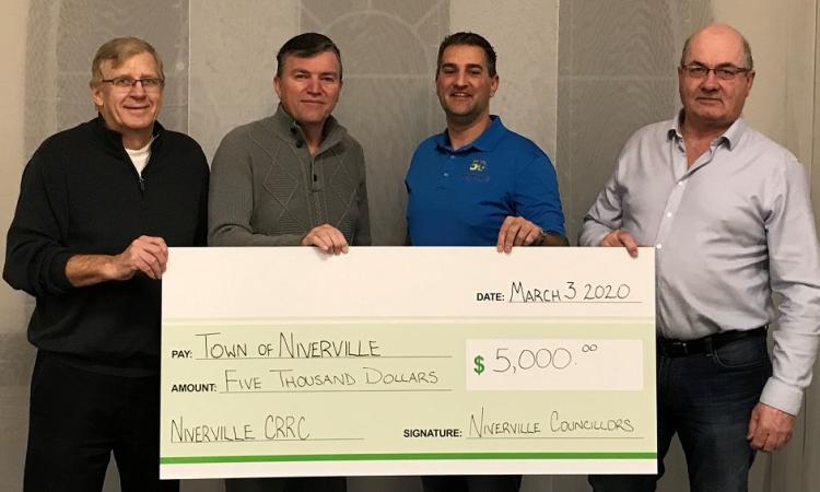 Councillor John Funk, Mayor Myron Dyck, Councillor Nathan Dueck, and Councillor Kevin Stott present their personal CRRC donation. Missing: Councillor Chris Wiebe.