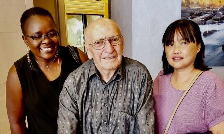John Plett alongside PCH aides Grace and Li.