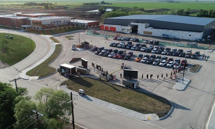 The first-ever crop of Niverville High School graduates comes forward to receive their diplomas at a unique curbside convocation.