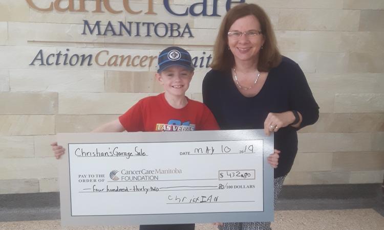Christian Harder with a staff member from Cancer Care Manitoba.