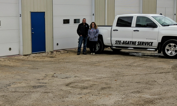 Alain and Rachel Robert in front of their nine-bay shop.