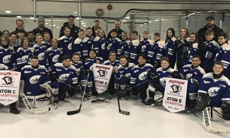 All three Atom Clippers teams, with their championship banners.