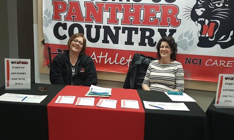 Leslie Bardal (left) and Heather Miller (right) at a PAC kiosk.