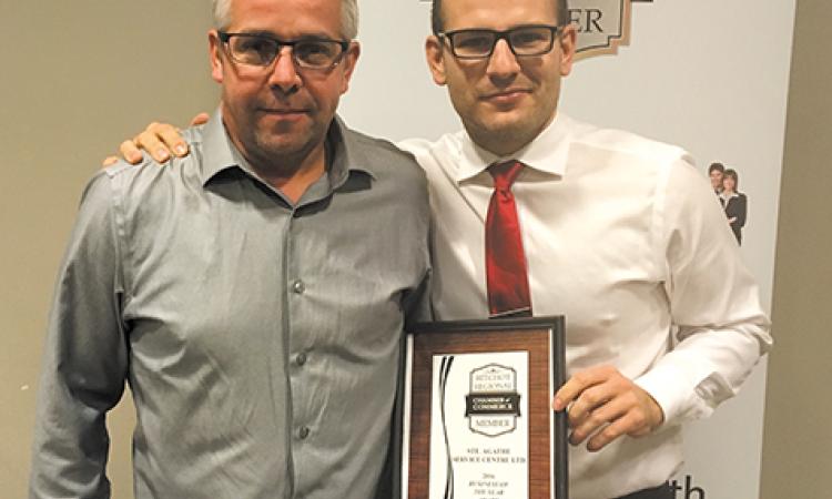 Chris Ewen (right) presents award to Alain Robert, owner of Ste Agathe Service (left