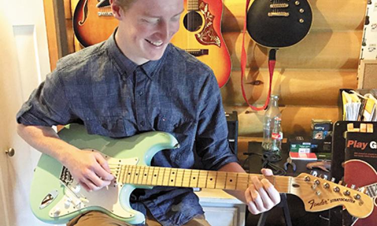 Justin Braun will be offering guitar lessons for a charitable cause