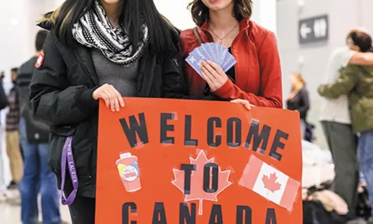 Canadians await the arrival of the first plane of Syrian refugees at Toronto's Pearson International Airport