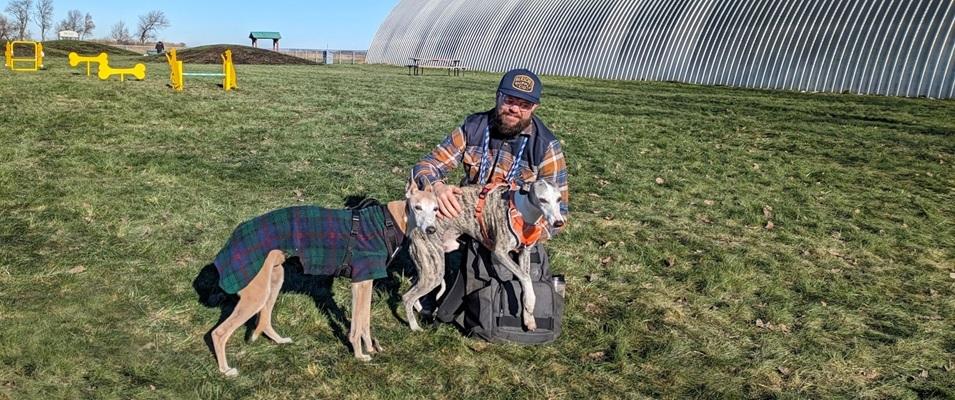 Kelvin Cech at the dog park with Rebis and Dasher.