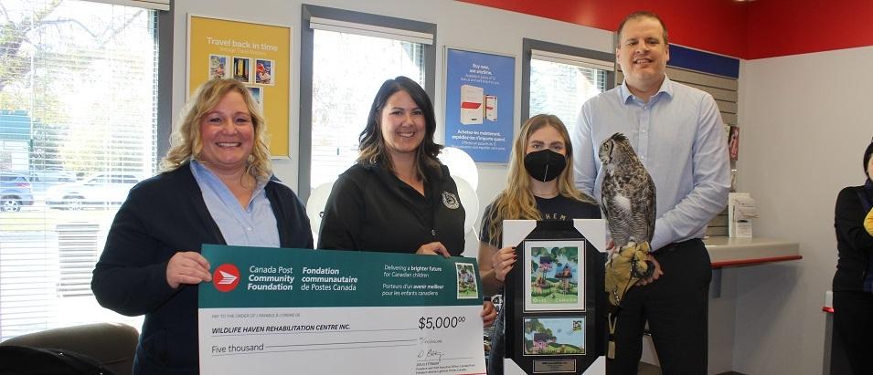 The Canada Post Foundation presents a cheque to the Wildlife Haven Rehabilitation Centre.