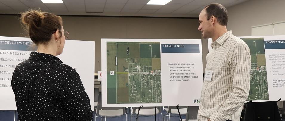 James Kennedy of of Morrison Hershfield speaks with a resident of Niverville at an open house to discuss the future build-out of Highway 311.