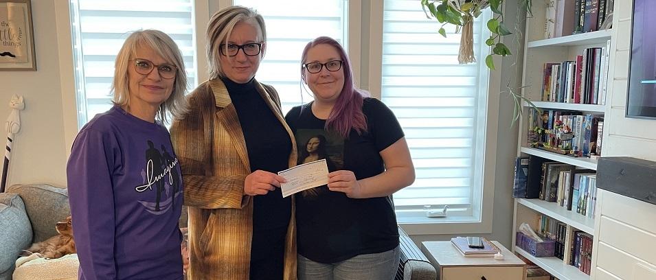 Mona Stott and Mona Dumont present Imagine's donation to Nadine Huberdeau.