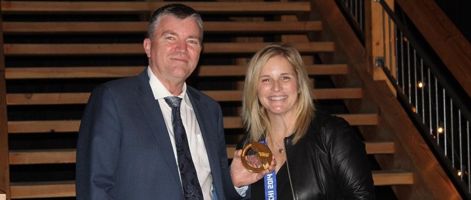 Niverville Mayor Myron Dyck alongside Jennifer Jones and her gold medal from Sochi 2014.