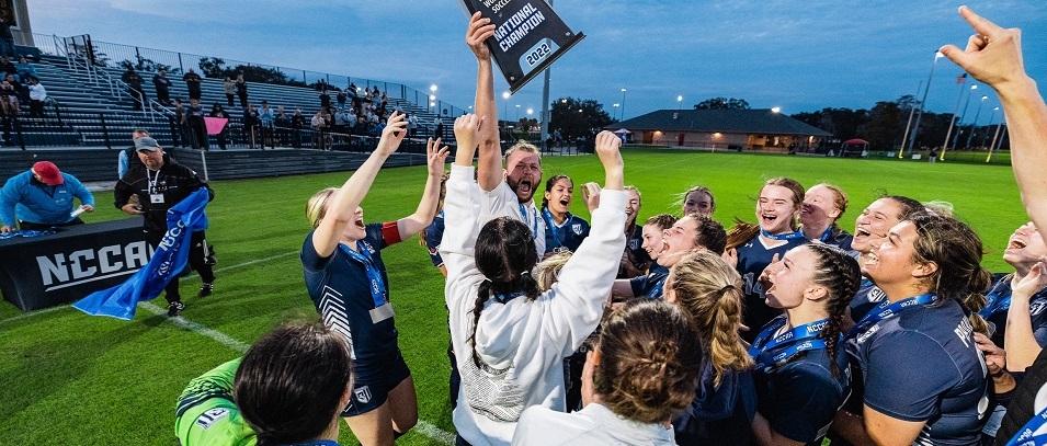 The Providence Pilots women's soccer team celebrate winning the NCCAA national championship.