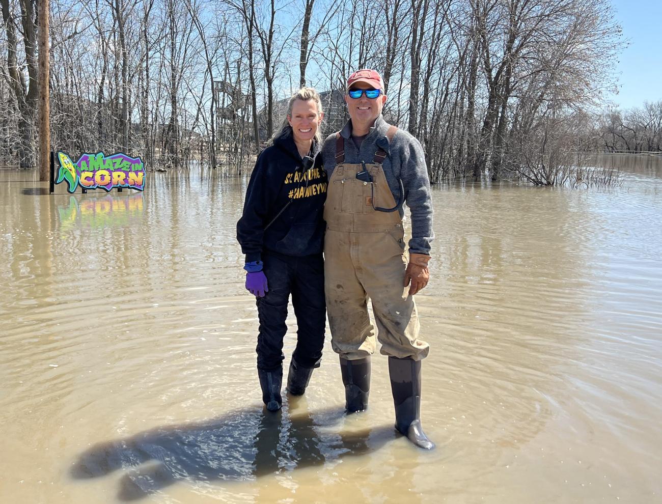 Angie and Clint Masse amidst floodwaters at their business, A Maze in Corn.