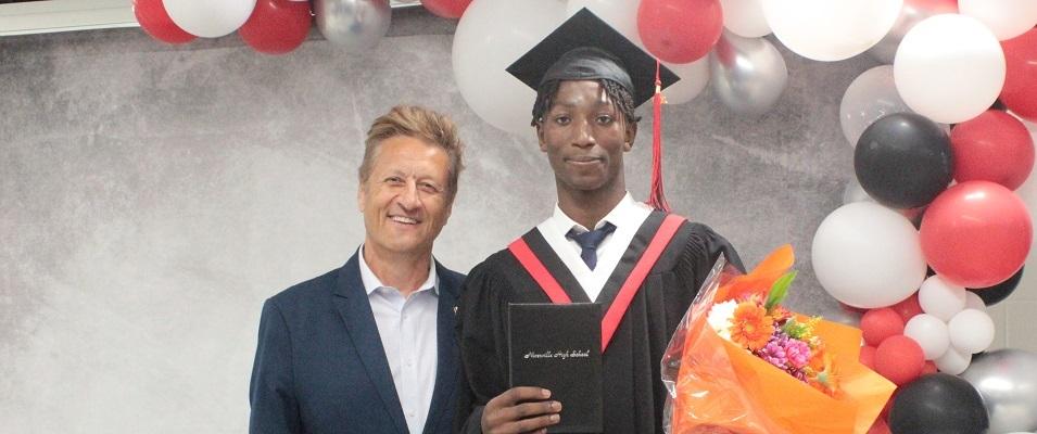 Graduate Michael Katotoka receives the Ron R. Schuler Citizenship Award.