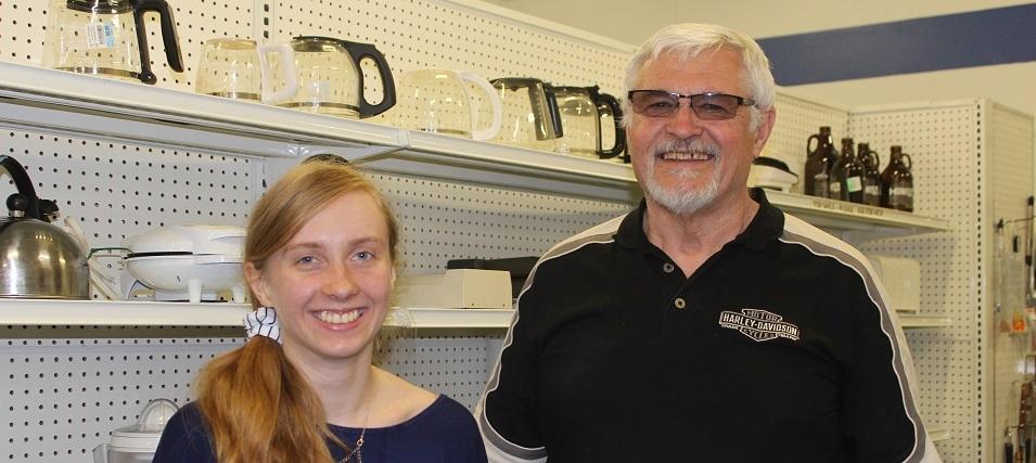 Student volunteer Keona Sturby and MCC Thrift Store acting general manager Gerald Loeppky.