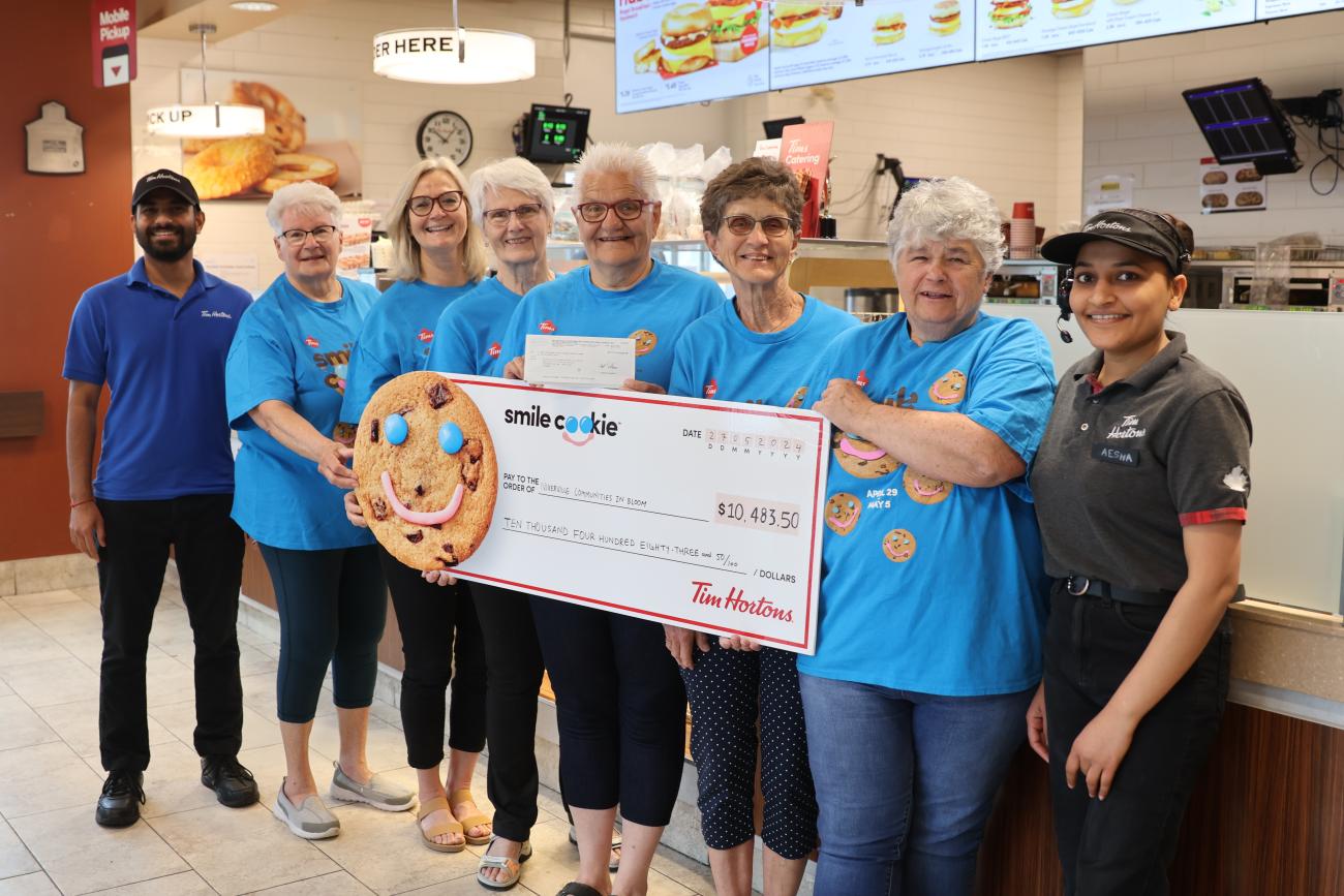 Volunteers for Niverville's mobility van fundraising committee receive a cheque from the Niverville Tim Horton's staff.