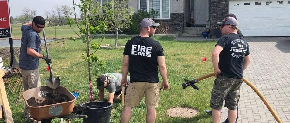 On a previous year's tree-planting day, volunteers from the Niverville Fire Department arrive to water new trees.