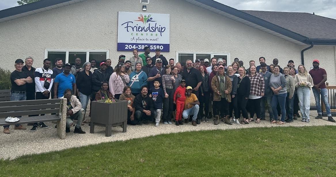 The Niverville fair committee gathers with the Wonder Shows crew on the Wednesday before the fair.