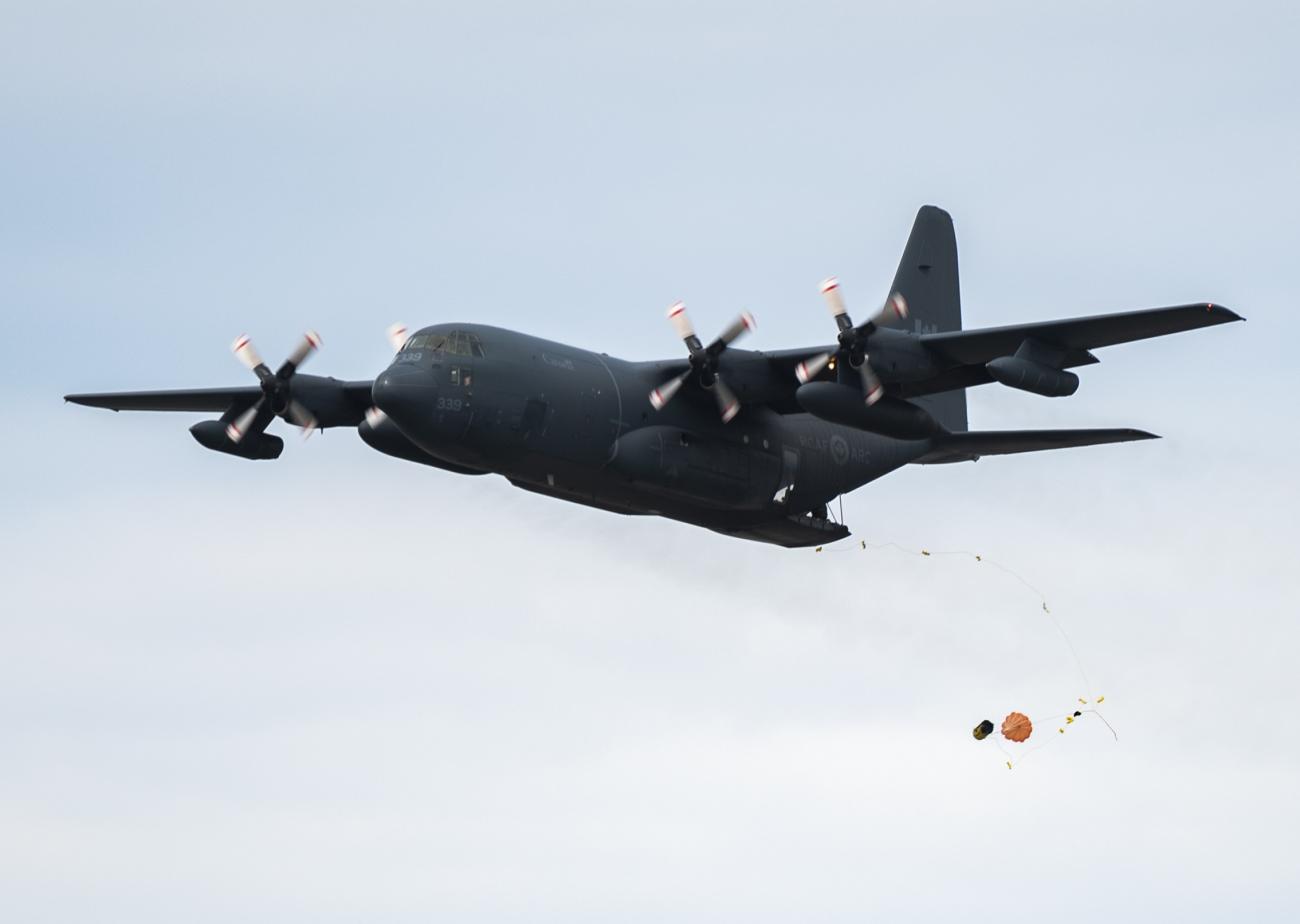 A CC-130 Hercules dispatches a survival raft during training on 25 July, 2022 over Lake Winnipeg in Gimli, Manitoba.