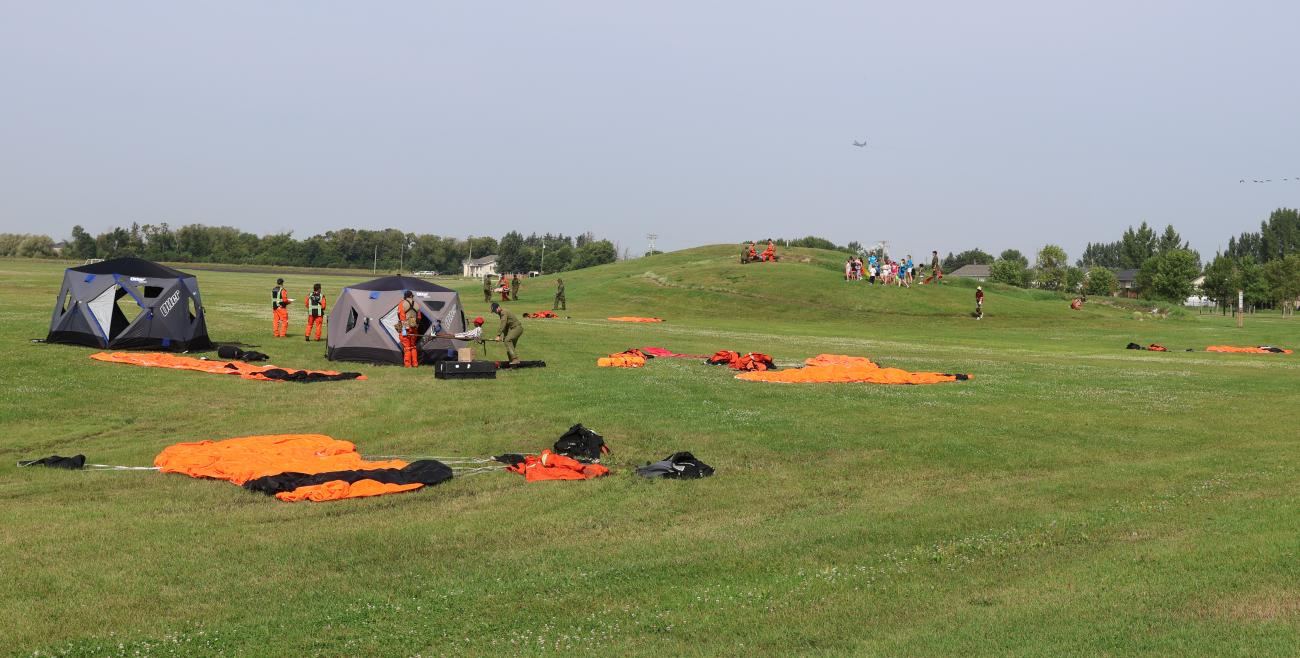 On the ground after the parachute drop, responders set up triage tents and attended to simulated injuries.