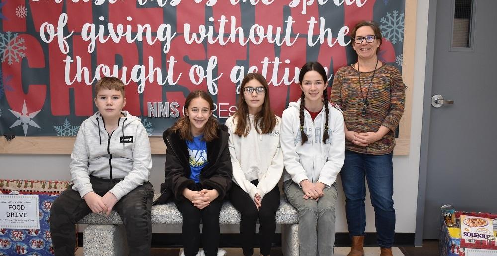 Members of SWAG, alongside teacher Laura van den Brul, on the school’s new bench.
