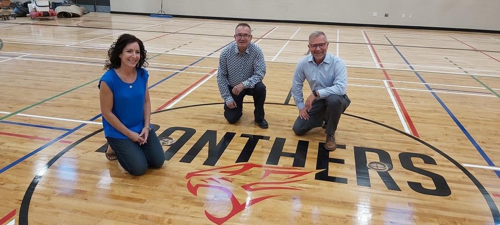 Principal Kimberley Funk, HSD Director of Facilities Bob Proulx, and HSD Superintendent Randy Dueck in the Niverville High School gymnasium.