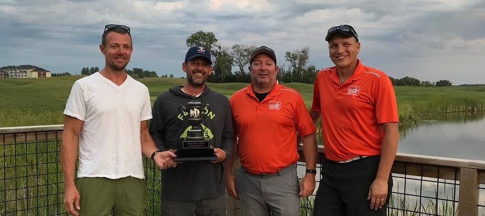Cory Funk and Kurt Funk receive their championship trophy from last year’s winners, Bryan Trottier and Ray Dowse.