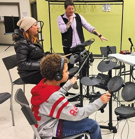 Elijah and his mom pick up the sticks at Niverville Winterfest with Kirkwood's encouragement