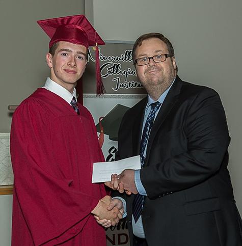 Riley Hiebert accepting The Citizen bursary from editor Evan Braun