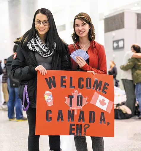Canadians await the arrival of the first plane of Syrian refugees at Toronto's Pearson International Airport